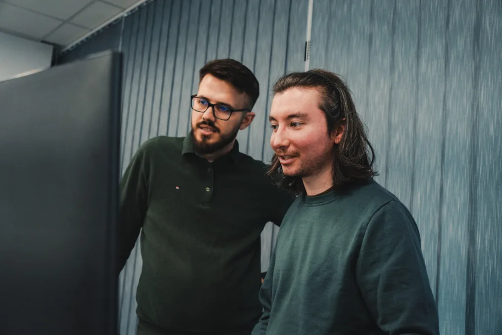 colleagues looking at their monitor